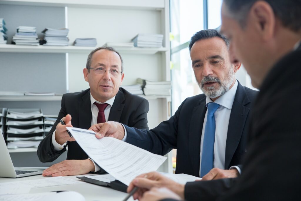 Men in Black Suit Having Conversation at Work